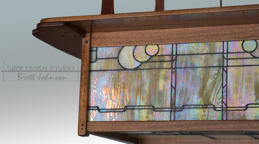 Arts and Crafts chandelier in the Greene and Greene tradition with handcrafted leaded stained glass and patinated copper details.